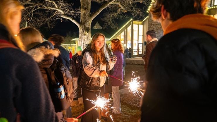Students gather in front of Sadove for the annual Lighting of Our Village ceremony