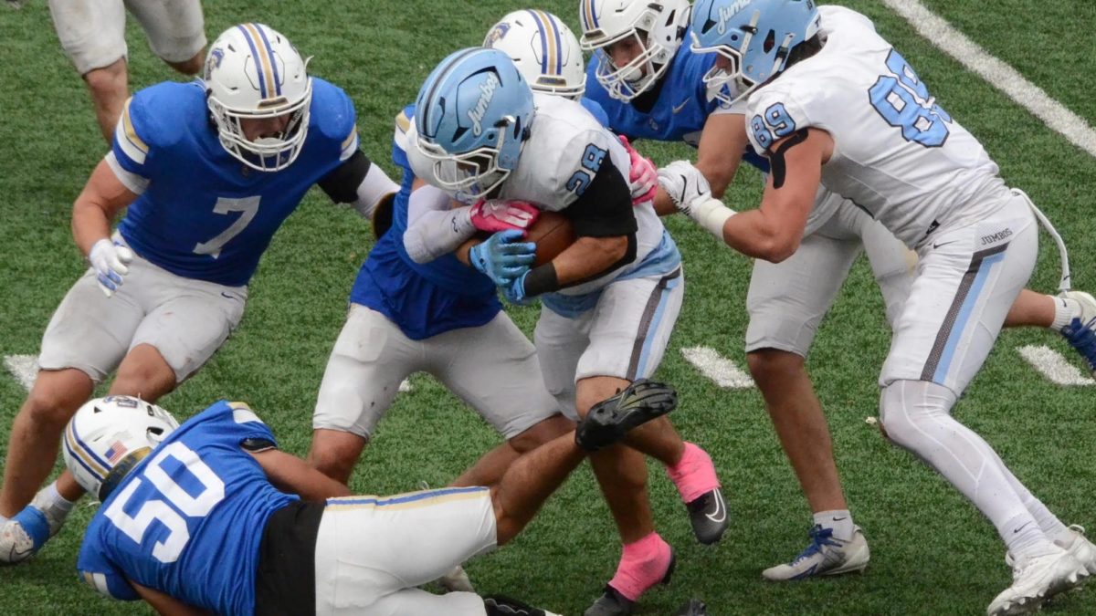 Hamilton defenders swarm Tufts running back Shapiro ’27 who ran for two TDs.